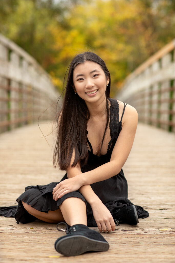 Senior photoshoot at Gallup Park in Ann Arbor with water, bridges, and lush greenery