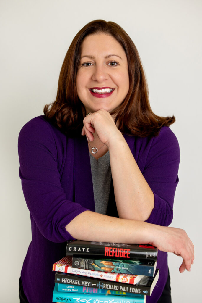 A polished headshot of Katie, an educator and Instagram creator, smiling confidently in a well-lit Northville studio setting.