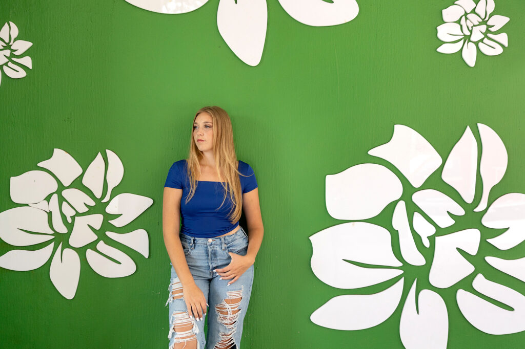 High school senior in downtown Ann Arbor featuring vibrant color mural.