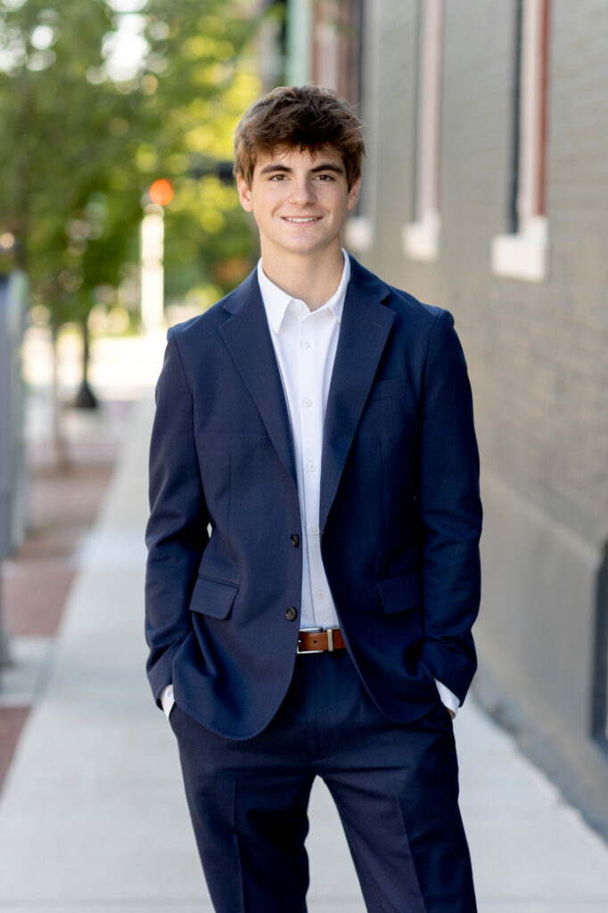 Charming senior photoshoot in Kerrytown, Ann Arbor, with historic brick buildings and tree-lined streets.